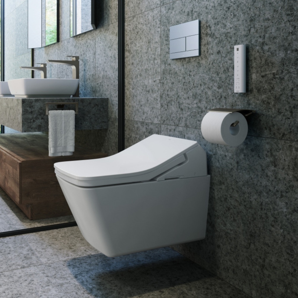 Lifestyle image of the TOTO Washlet SX Rimless Wall Hung Toilet mounted against a grey bathroom wall, below a silver dual flush plate